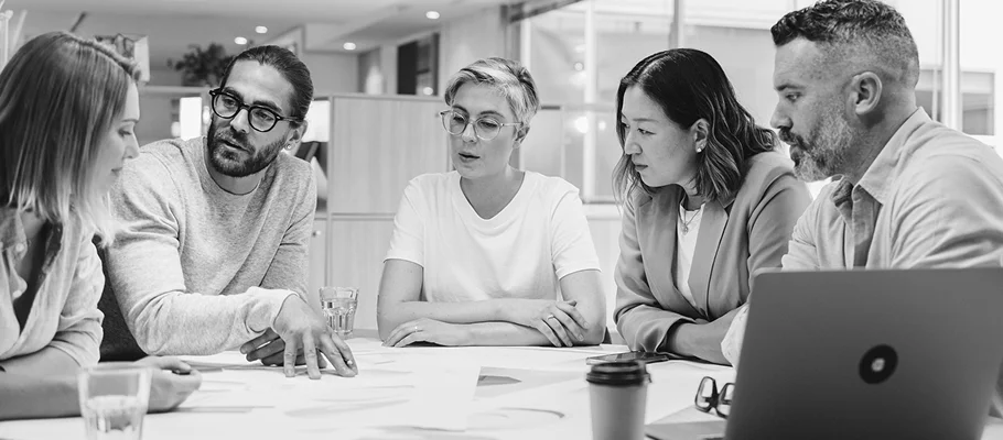 Professional business consulting team discussing strategy and working together in a modern office
